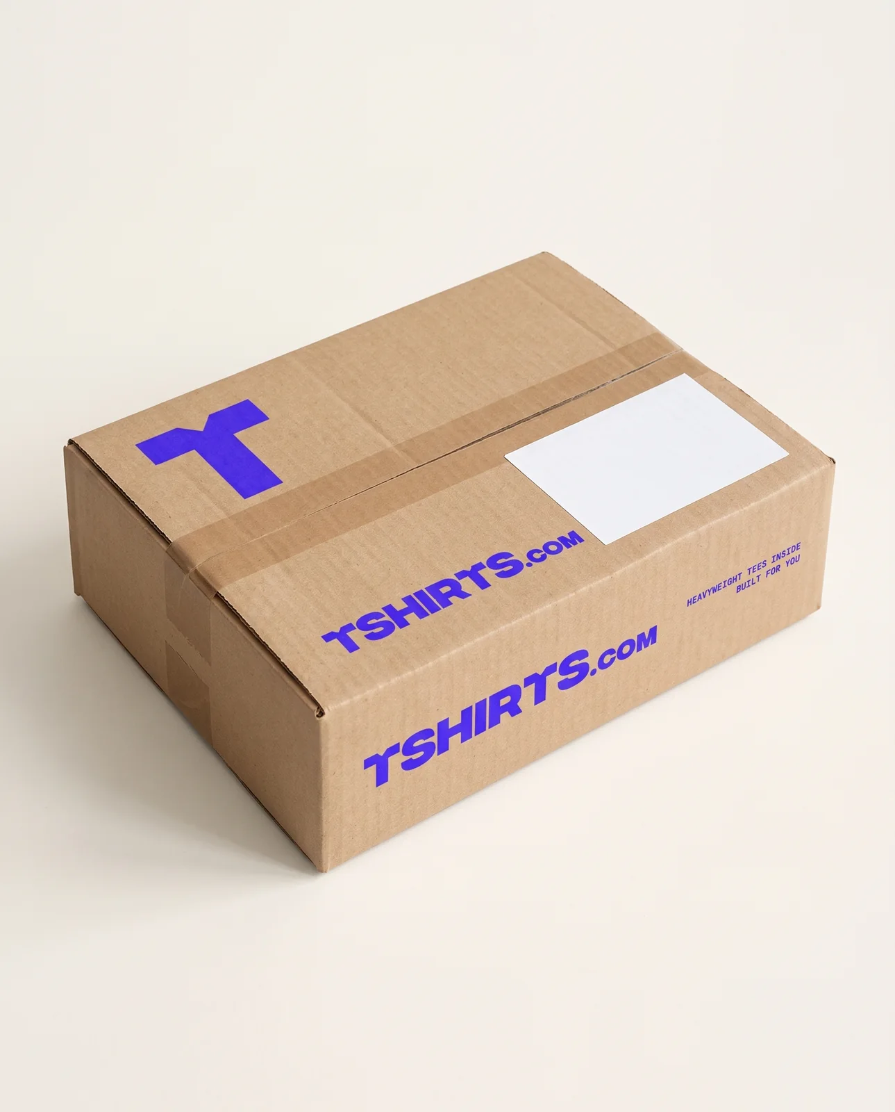 Natural kraft shipping box printed with the blue TSHIRTS.com wordmark