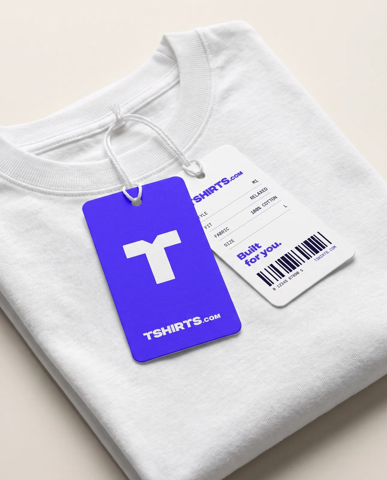 Electric-blue and white TSHIRTS.com hang tag tied to a folded tee