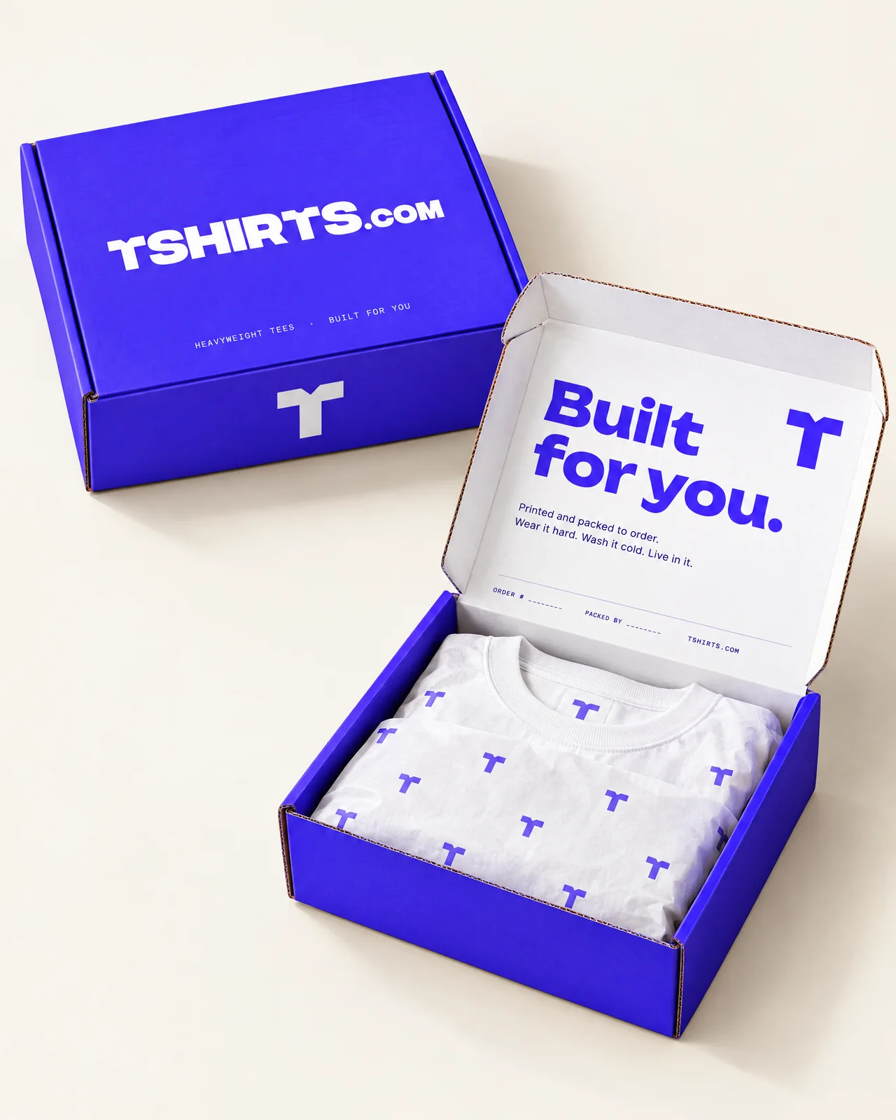 Electric-blue TSHIRTS.com mailer box with Built for you printed inside the lid